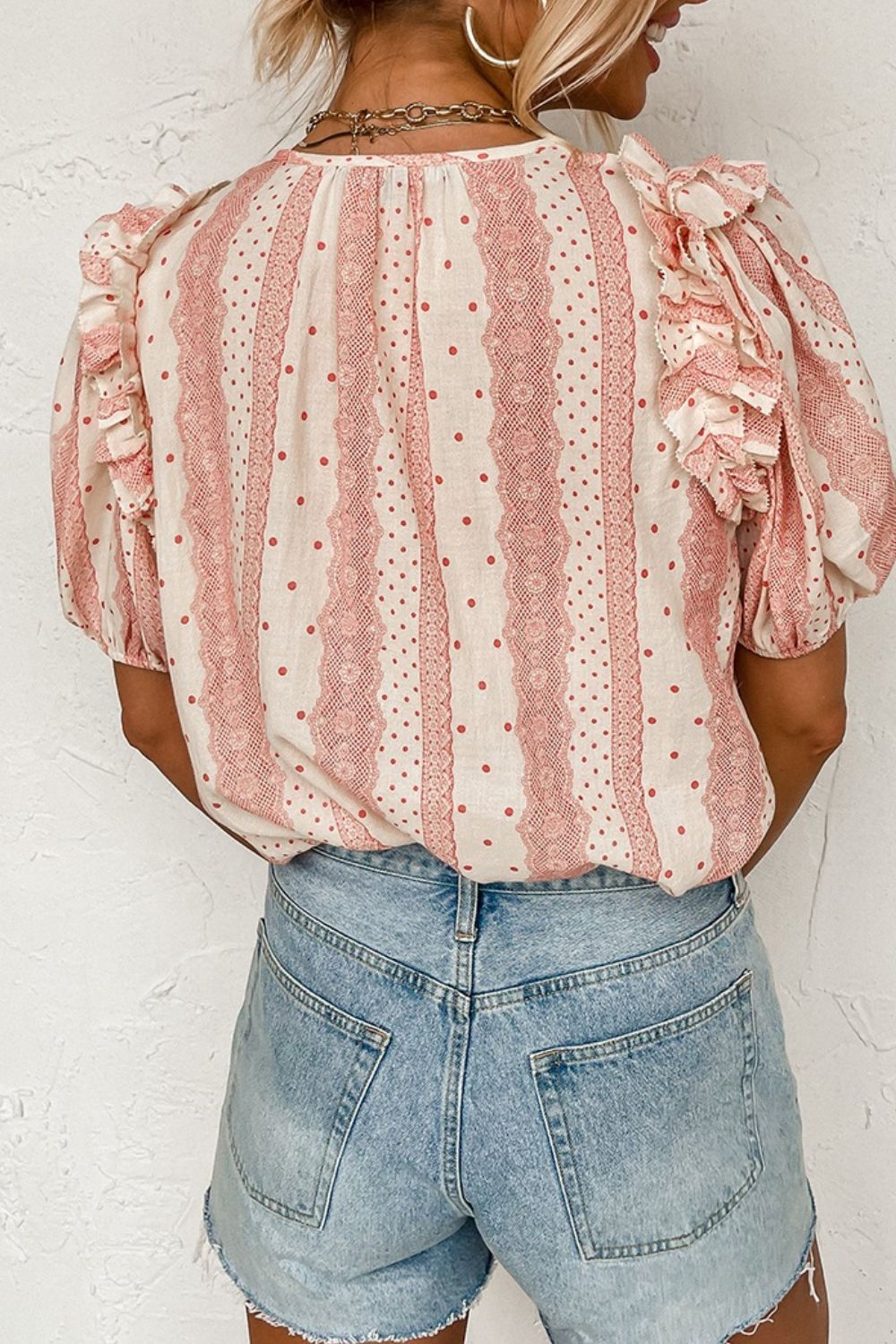 Bohemian print blouse in burnt coral with ruffle yoke and polka dots, 100% viscose.