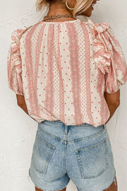 Bohemian print blouse in burnt coral with ruffle yoke and polka dots, 100% viscose.