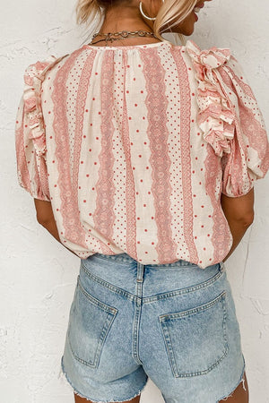 Bohemian print blouse in burnt coral with ruffle yoke and polka dots, 100% viscose.