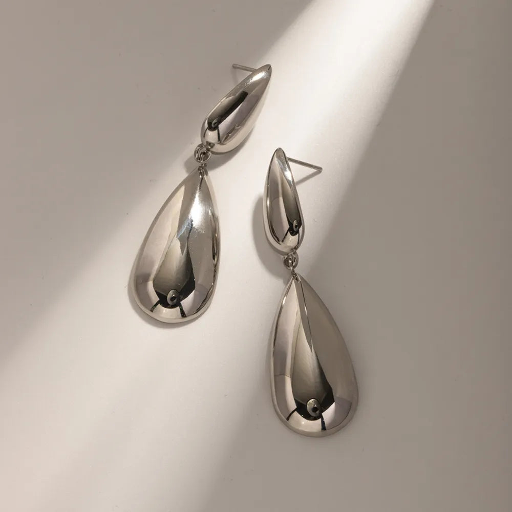 Silver teardrop dangle earrings with a polished finish.