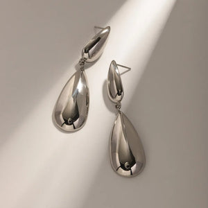 Silver teardrop dangle earrings with a polished finish.