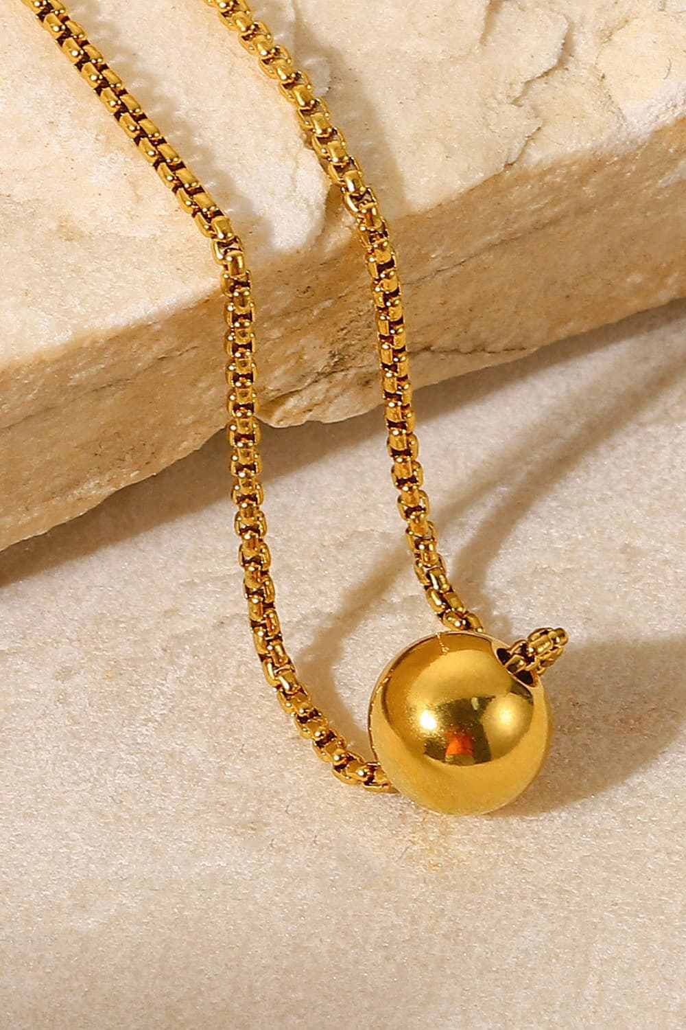 Golden Orb pendant necklace with a box chain.