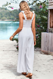 White smocked bodice tie-strap palazzo jumpsuit with wide legs.
