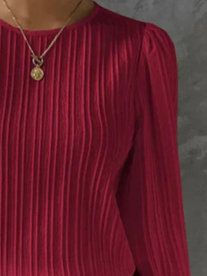 Burgundy pleated blouse with gathered shoulders and crew neck.