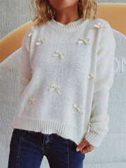 White knit crewneck sweater with allover bow embellishments