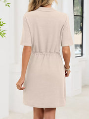 Textured polo dress in apricot with short sleeves and adjustable drawstring waist.