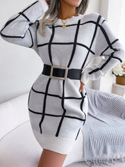 White geometric grid knit mini dress with crew neck and long sleeves, styled with a black belt.