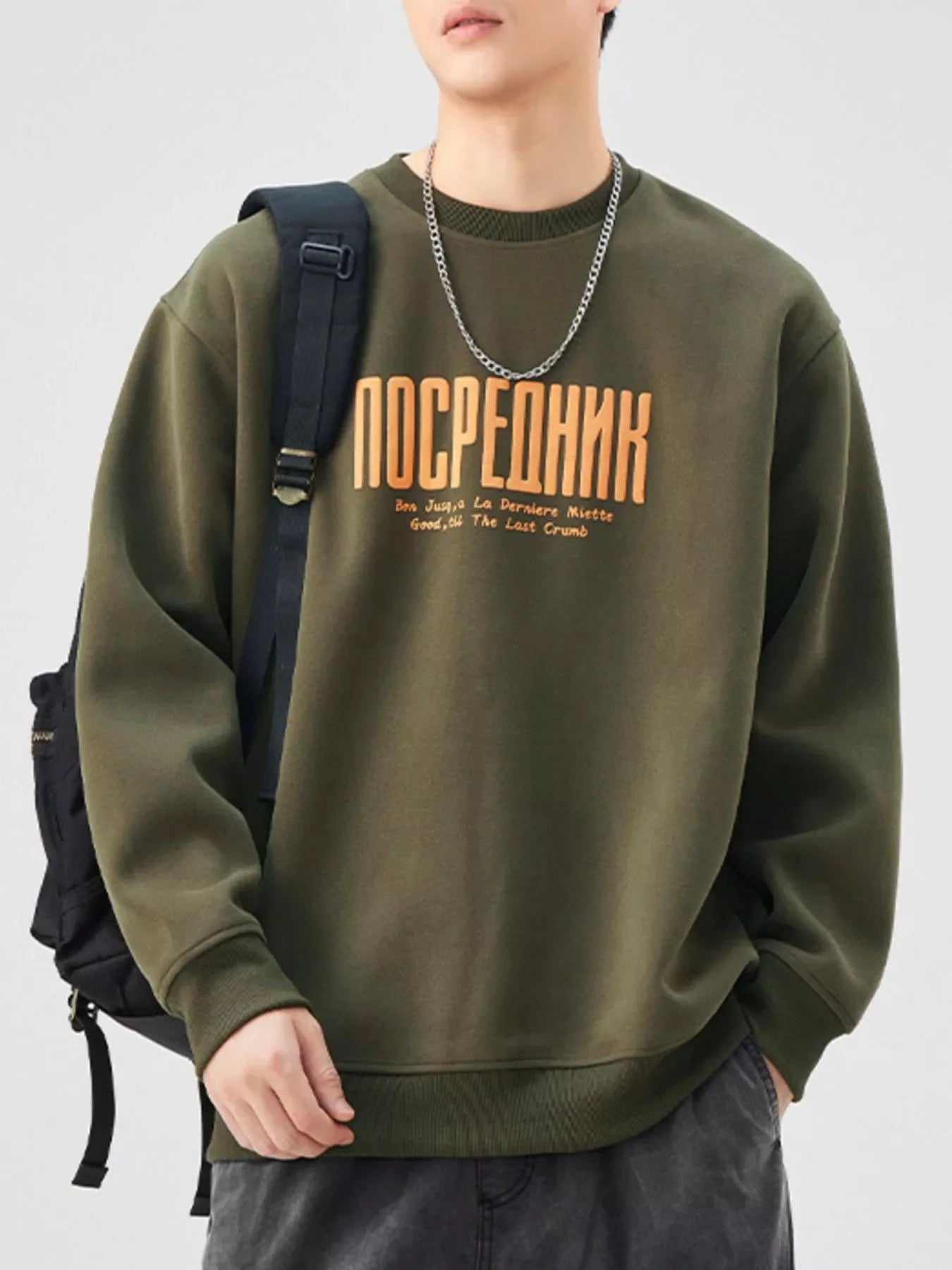 Oversized graphic sweatshirt in Army Green cotton blend with crewneck and ribbed cuffs.