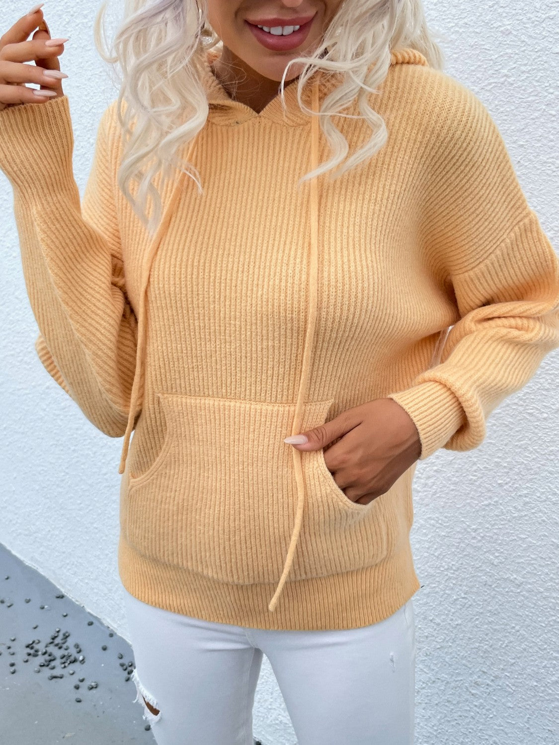 Yellow textured knit cocoon hoodie with drawstring and front pocket.