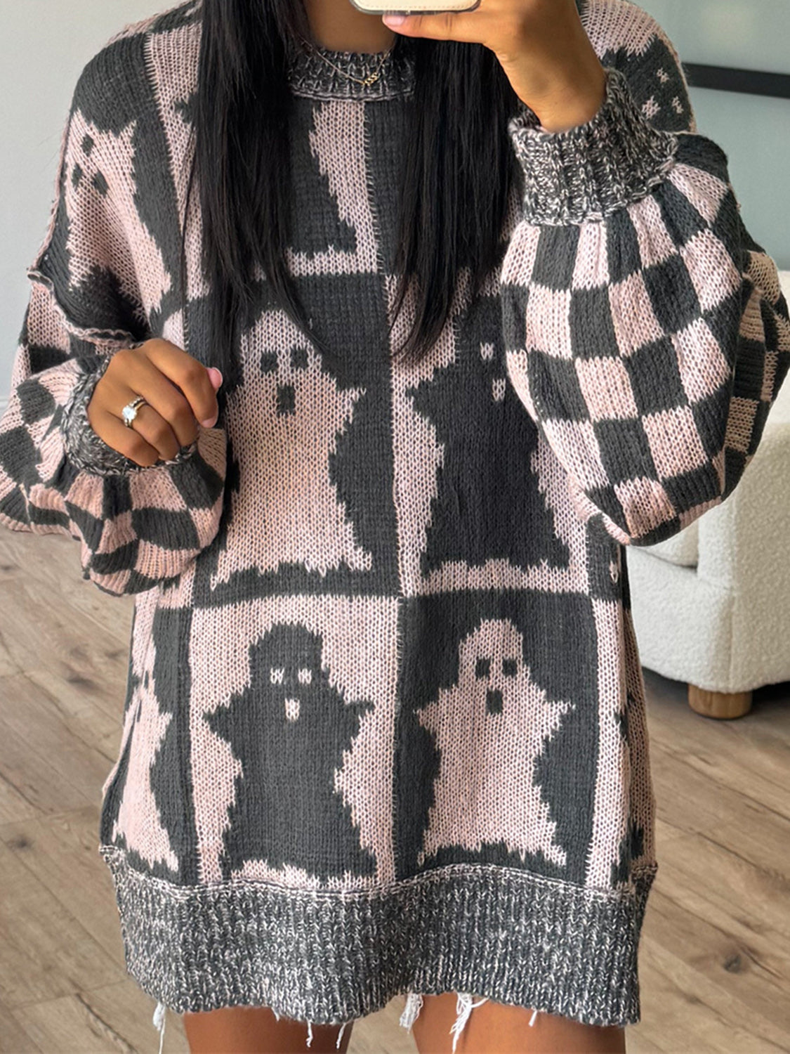 Ghost checkered knit sweater in black and dusty pink with balloon sleeves and a distressed hem.