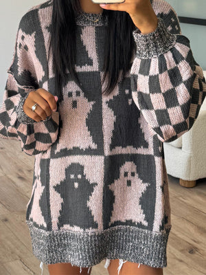 Ghost checkered knit sweater in black and dusty pink with balloon sleeves and a distressed hem.