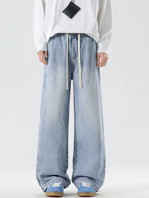 Oversized drawstring washed denim jeans in light blue with a relaxed fit.