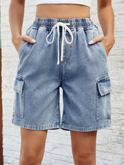 Denim cargo shorts in dusty blue with drawstring waist and side pockets.