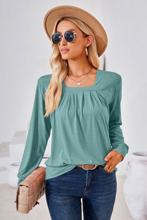 Teal jersey top with gathered square neckline and long sleeves.