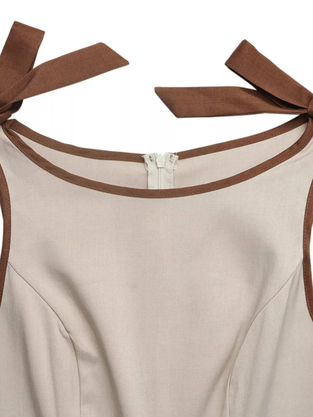 Cream romper with brown trim and bow shoulder accents, zipper closure.