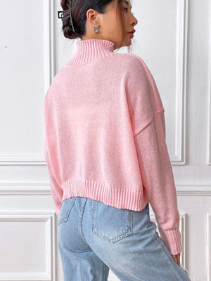 Blush pink cropped turtleneck knit sweater with ribbed details and embroidered heart detail.