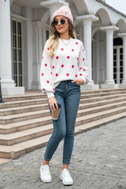White polka dot knit sweater with balloon sleeves and crew neck.