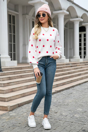 White polka dot knit sweater with balloon sleeves and crew neck.