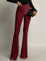 High-waisted flared trousers in red, with a fitted silhouette and wide leg opening.