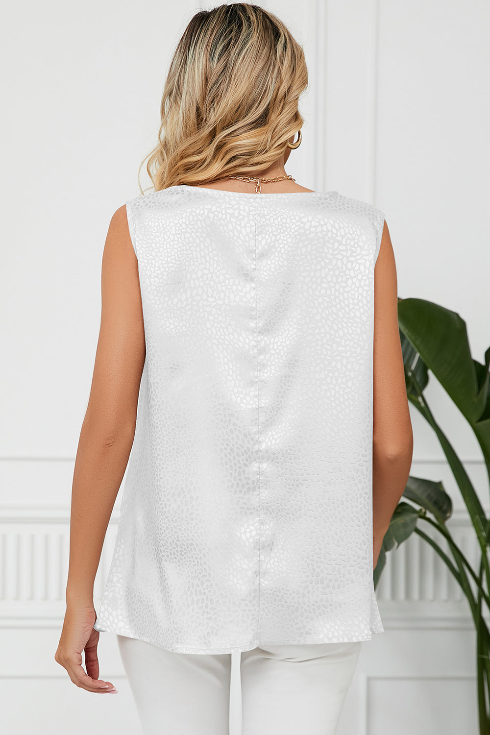 White jacquard tank top with a subtle all-over pattern, sleeveless with a drape neckline.