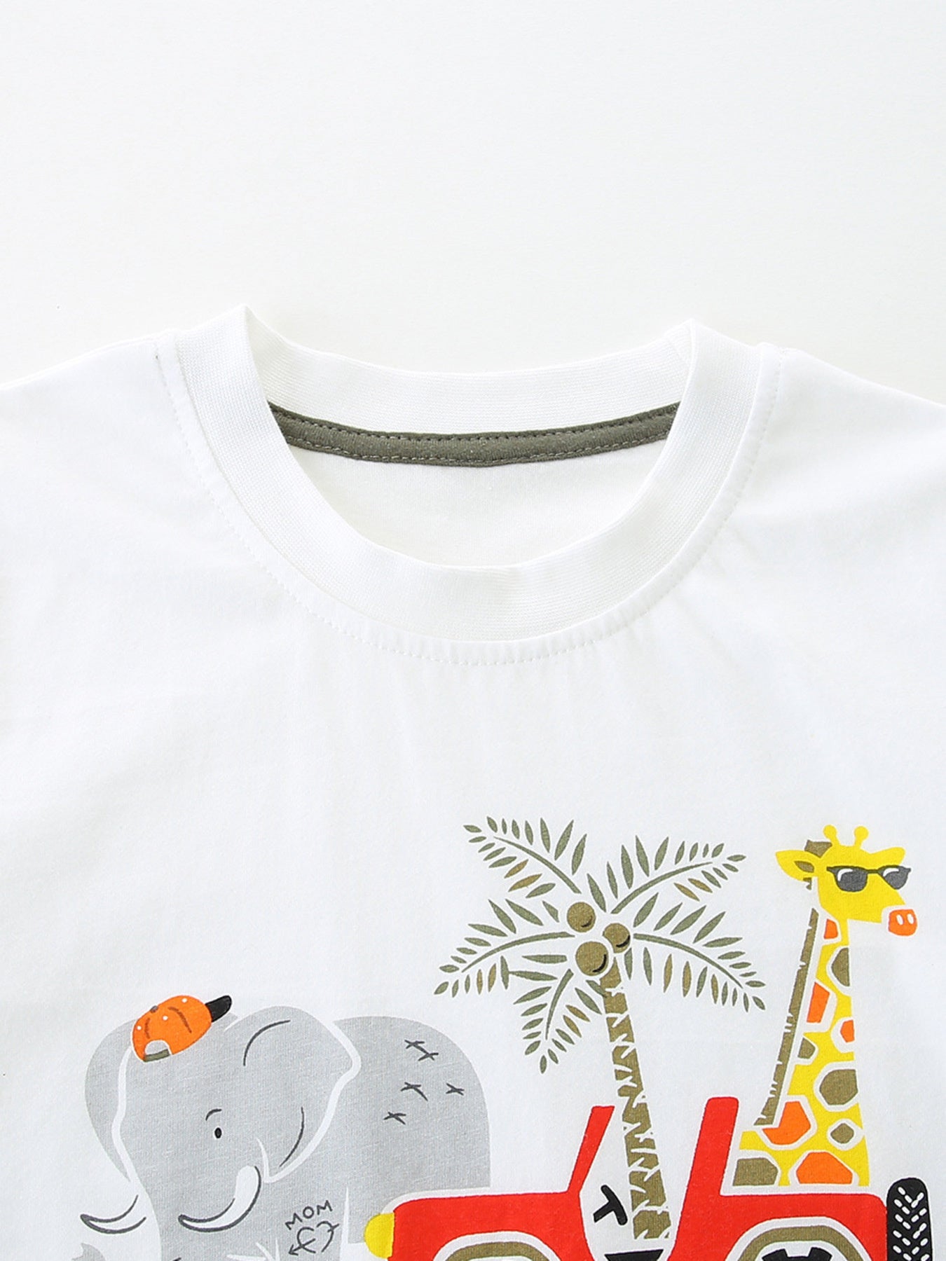 White cotton baby tee with safari graphic of elephant, giraffe, palm tree and jeep.