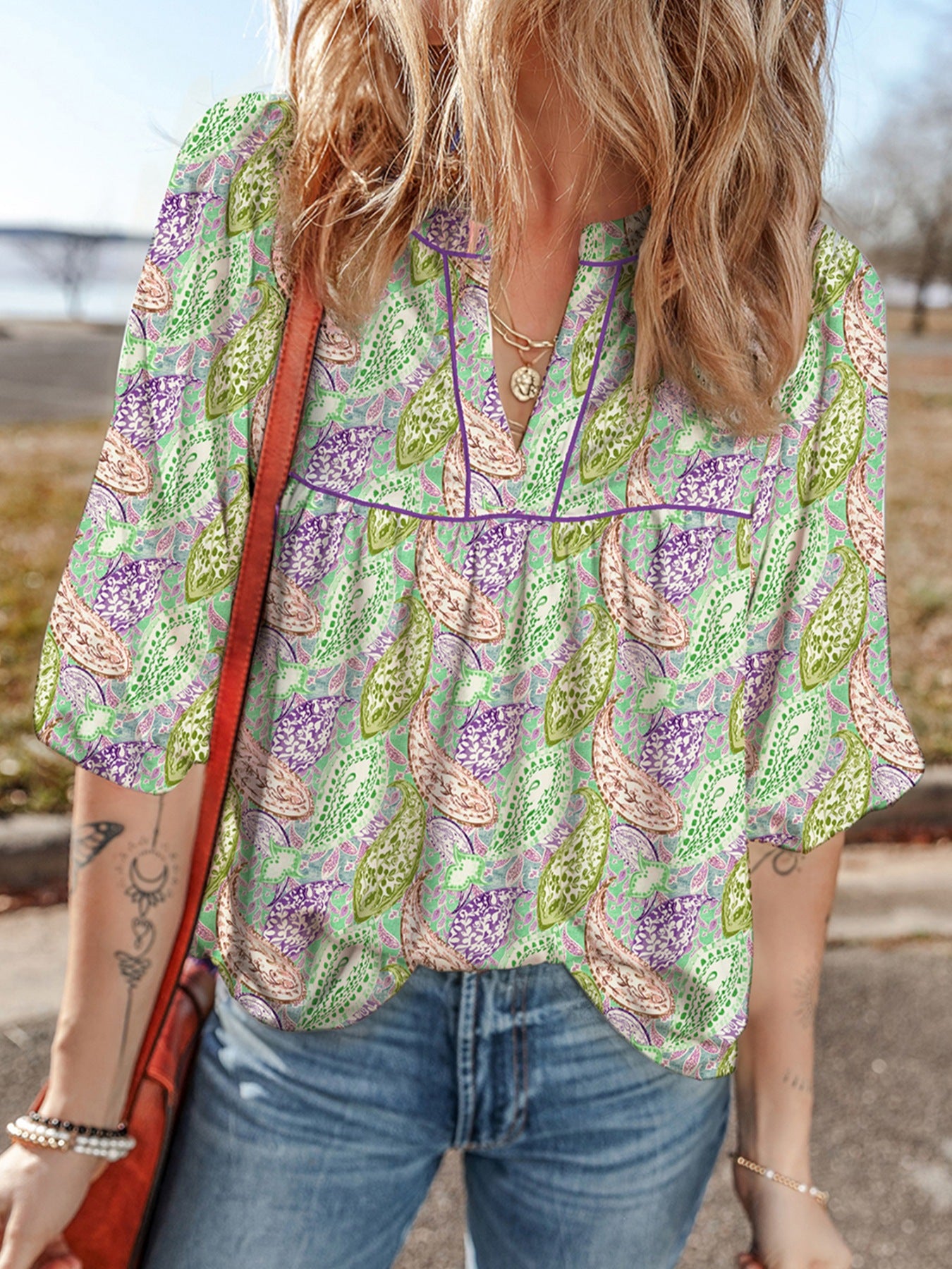 Paisley print puff sleeve blouse with V-neck and purple trim, in light green with purple and pink paisley.