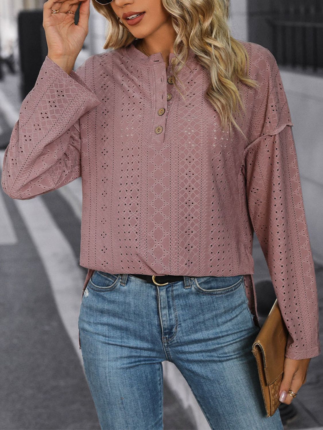 Dusty pink perforated henley shirt with slit hem and button detail.