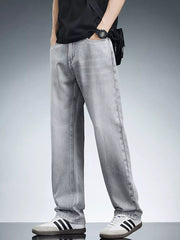 Men's light grey relaxed fit wide leg jeans in cotton, styled casually.
