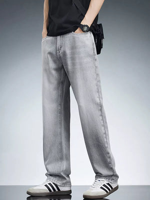 Men's light grey relaxed fit wide leg jeans in cotton, styled casually.