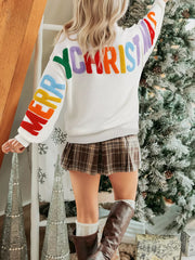 White chenille holiday sweater with colorful "Merry Christmas" lettering on sleeves and back.