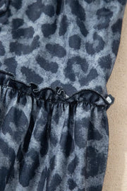 Maternity pants in dark navy with leopard print and a ruffled hem detail.