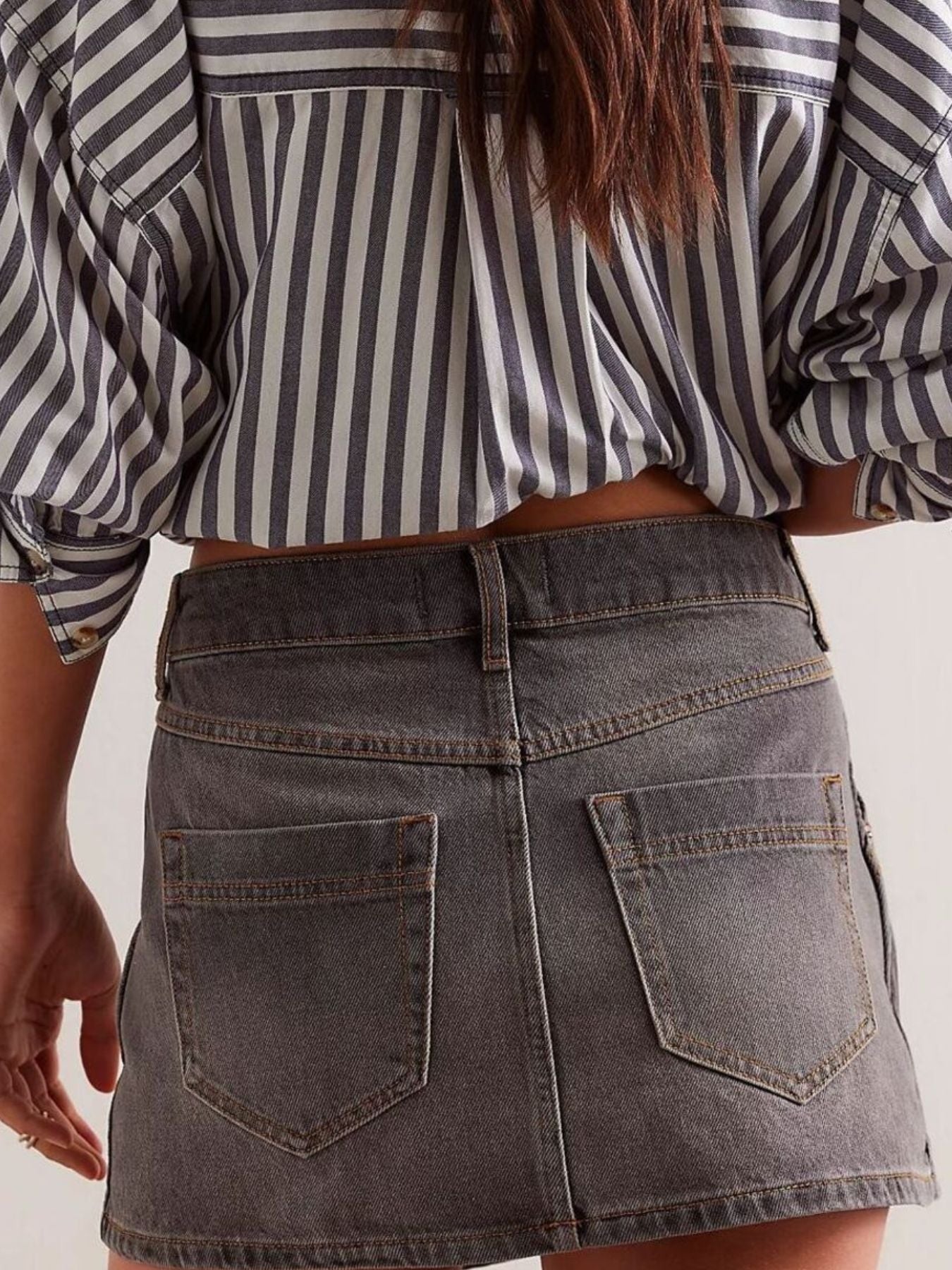 Gray denim skort with button front and five pockets.