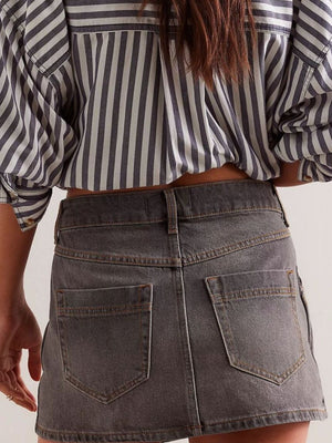Gray denim skort with button front and five pockets.