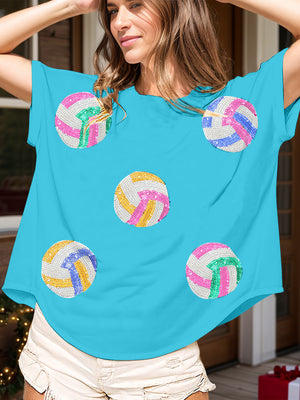 Sky blue t-shirt with sequin volleyball graphics in pink, green, yellow, and blue.