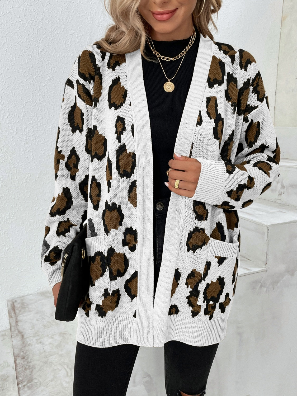 Leopard print open-front knit cardigan with white trim and pockets.