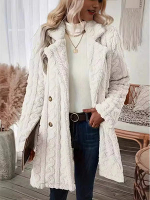 White faux shearling double-breasted overcoat with cable knit texture and button closure.