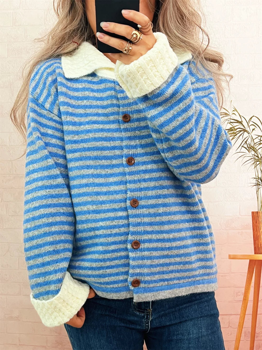 Blue striped knit cardigan with textured collar and button-down front.