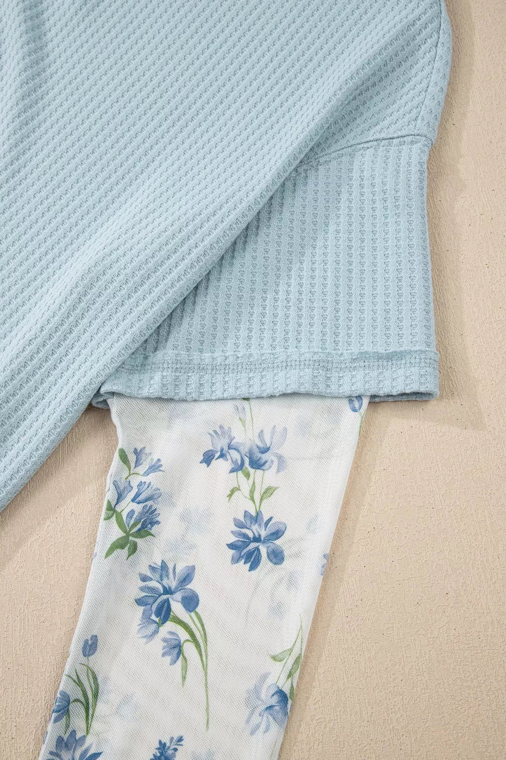Light blue waffle knit maternity overshirt with floral mesh sleeves.