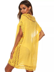Yellow crochet V-neck cover-up dress with intricate cutout details and fringe hem.