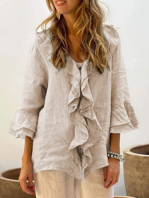 Ruffled linen blouse in light beige with flared sleeves and a V-neck.