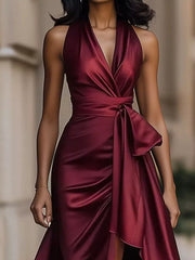 Wine red satin halter maxi dress with cinched waist and ruffled high-low skirt.