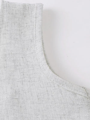 Baby vest detail in light grey textured fabric with clean stitching.