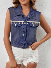 Classic button-up denim vest in dark blue with decorative trim and shell details.
