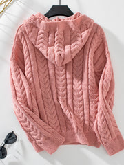 Cable knit hooded sweater in burnt coral with textured stitching and ribbed cuffs.