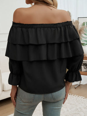 Black tiered ruffle off-shoulder blouse with long sleeves and ruffled cuffs.