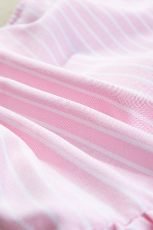 Blush pink striped peplum blouse with a textured fabric detail.