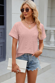 Blush pink perforated v-neck t-shirt with rolled sleeves and a chest pocket.