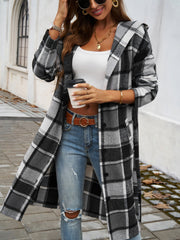 Checked plaid hooded duster coat in black and white, open front, buttoned detail.