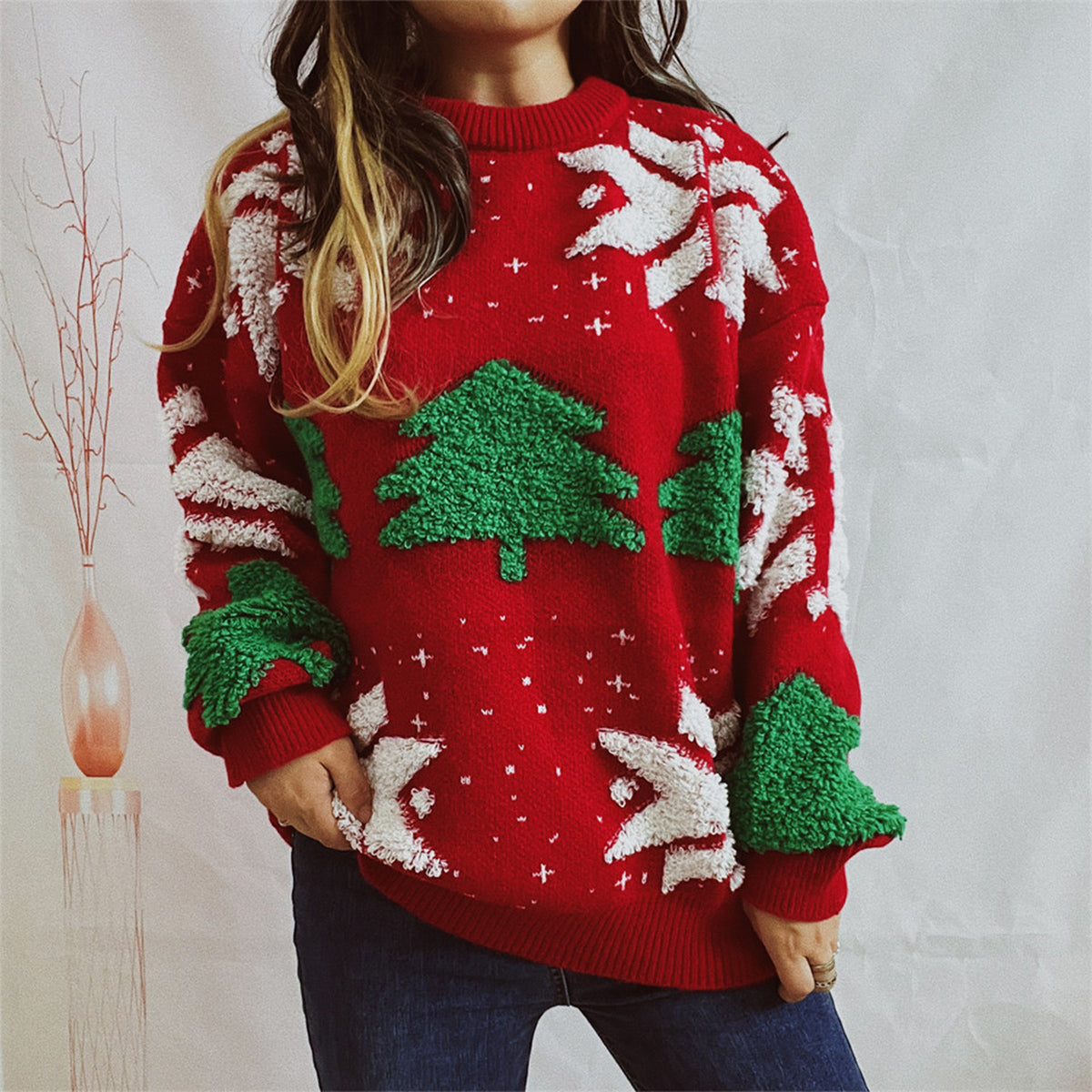 Red acrylic knit sweater with festive Christmas tree and snowflake appliqués.