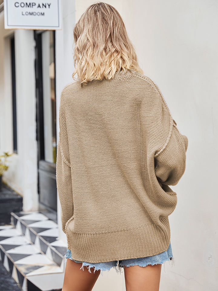 Oversized slouch knit V-neck sweater in cream, featuring a relaxed fit and breathable acrylic fabric.